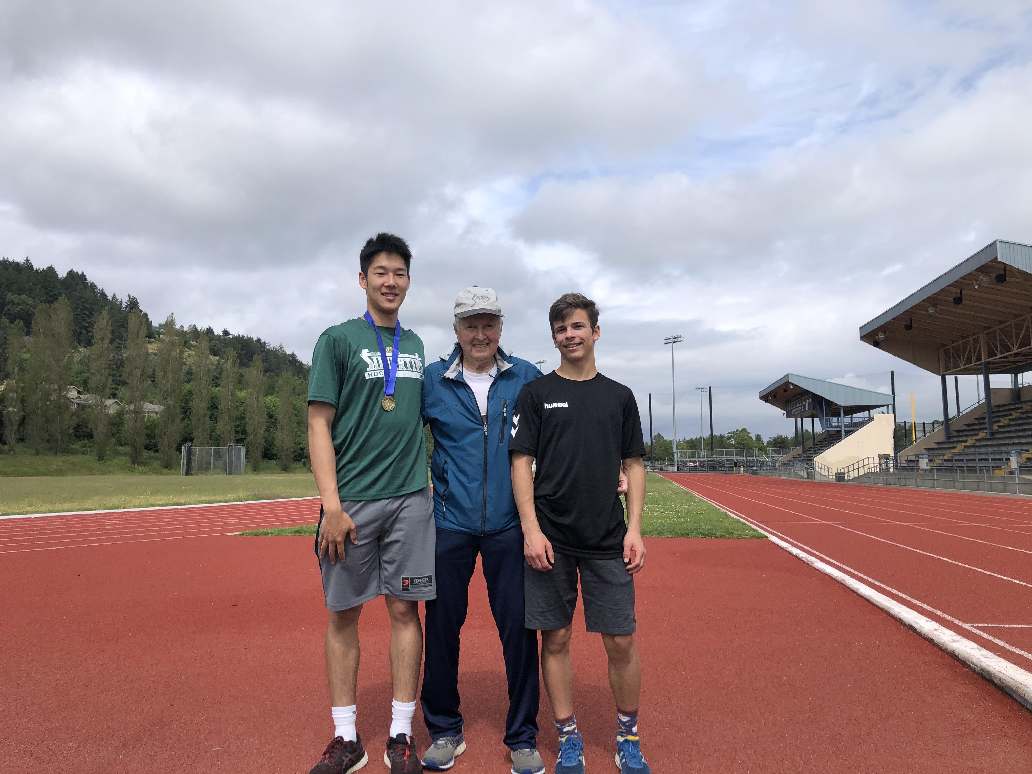 Head Coach Rod Constable with two Club Rapide athletes on the track